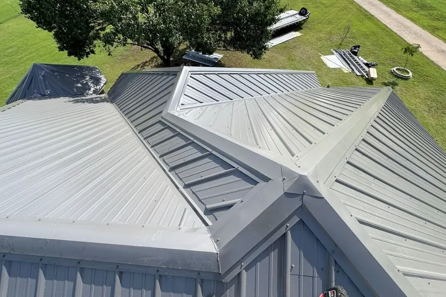 Aerial view of complex multi-angle metal roof installation showing precision trim work