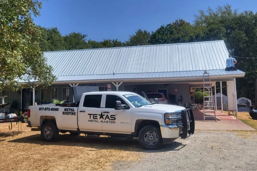Texas Metal Master branded truck at a completed job site