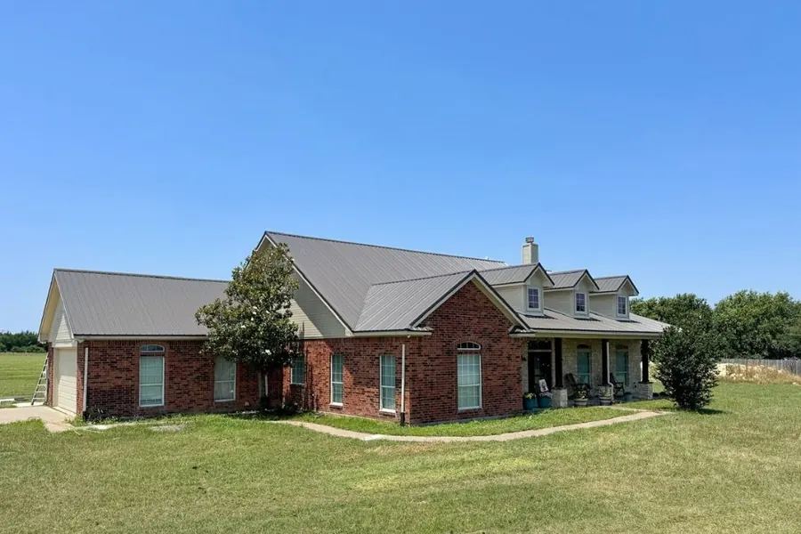 Large brick home with new metal roof in North Texas