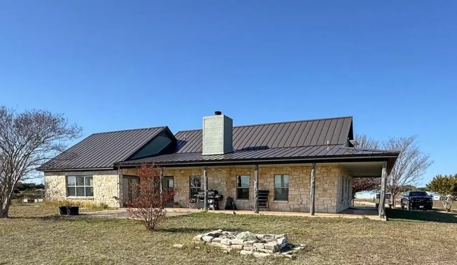 Texas stone ranch home with standing seam metal roof